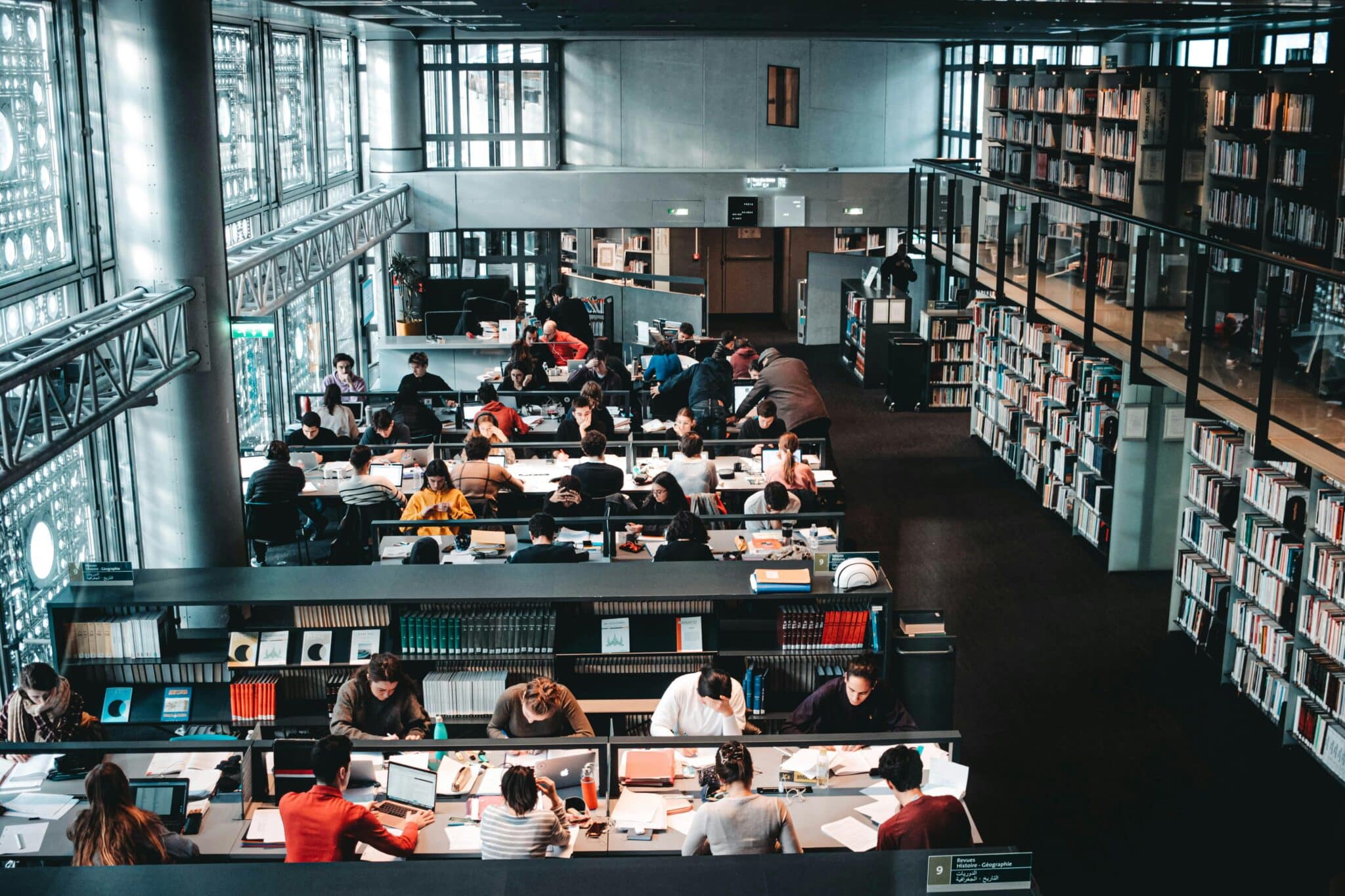 University and senior school students studying in a library, reflecting academic planning around Australian school holidays and term dates in 2026.