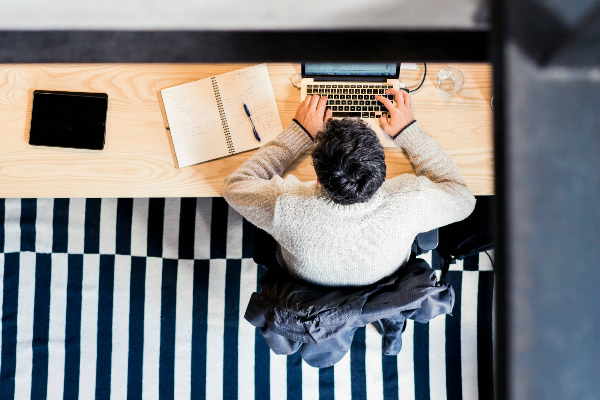 Student studying HSC English at a desk with a laptop, notebook, and study materials while analysing literary techniques.